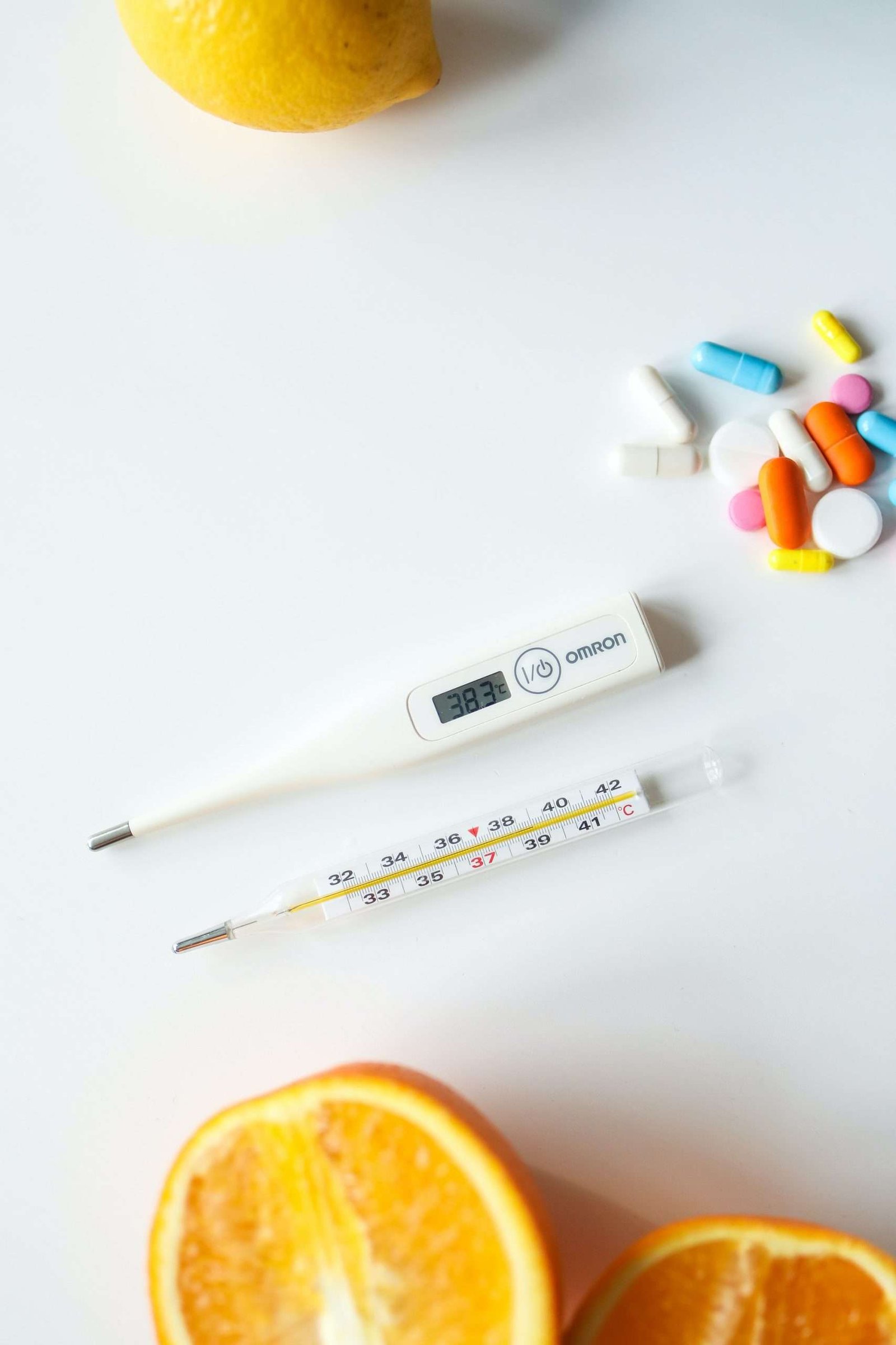 a thermometer and pills on a table